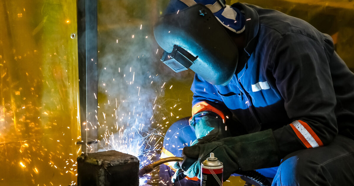 Male working with a welding torch